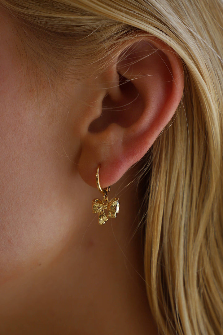 E1674G Gold Earrings-Bow Huggies